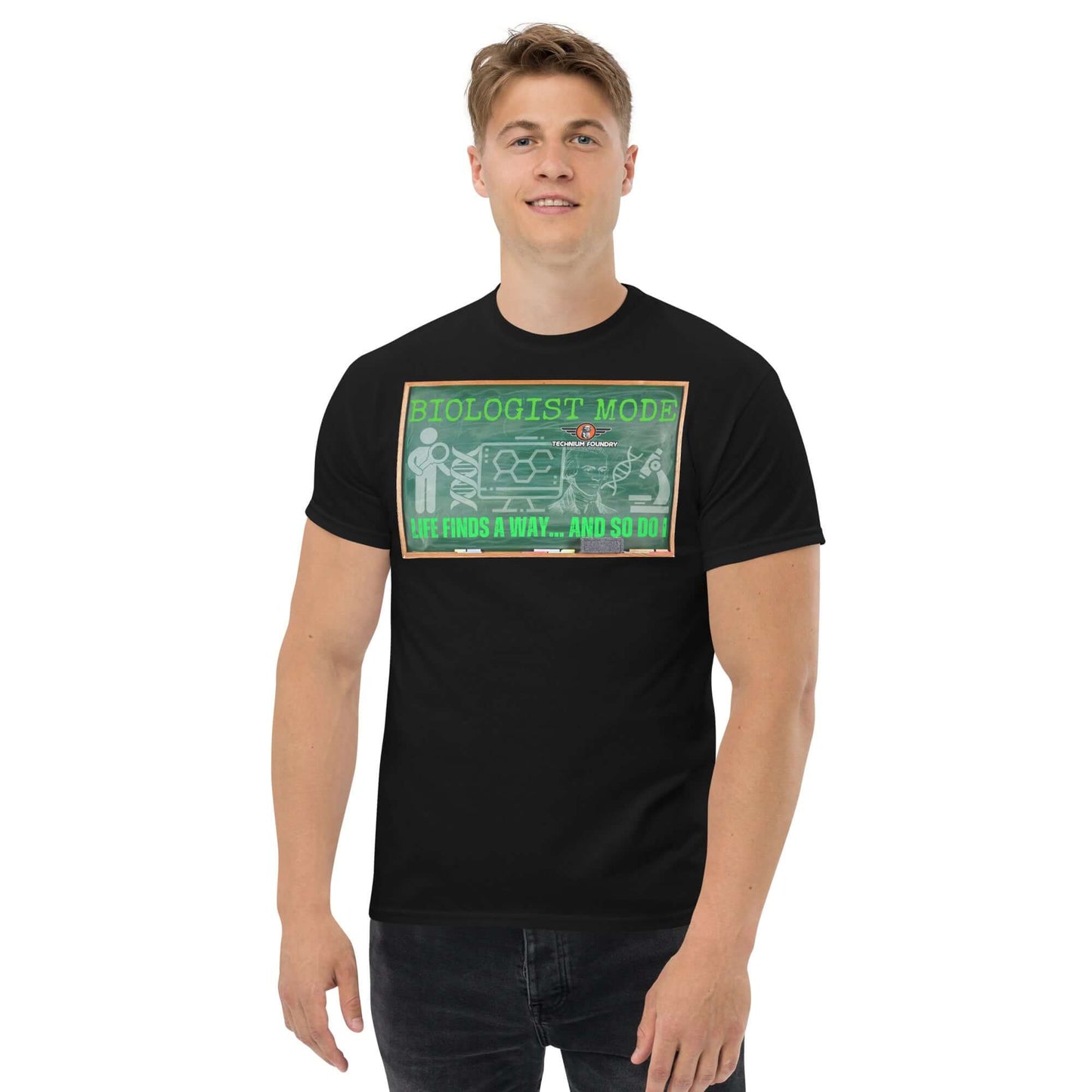 Male model wearing a black "Biologist Mode Life Finds A Way" t-shirt featuring DNA and scientific illustrations against a retro chalkboard design.