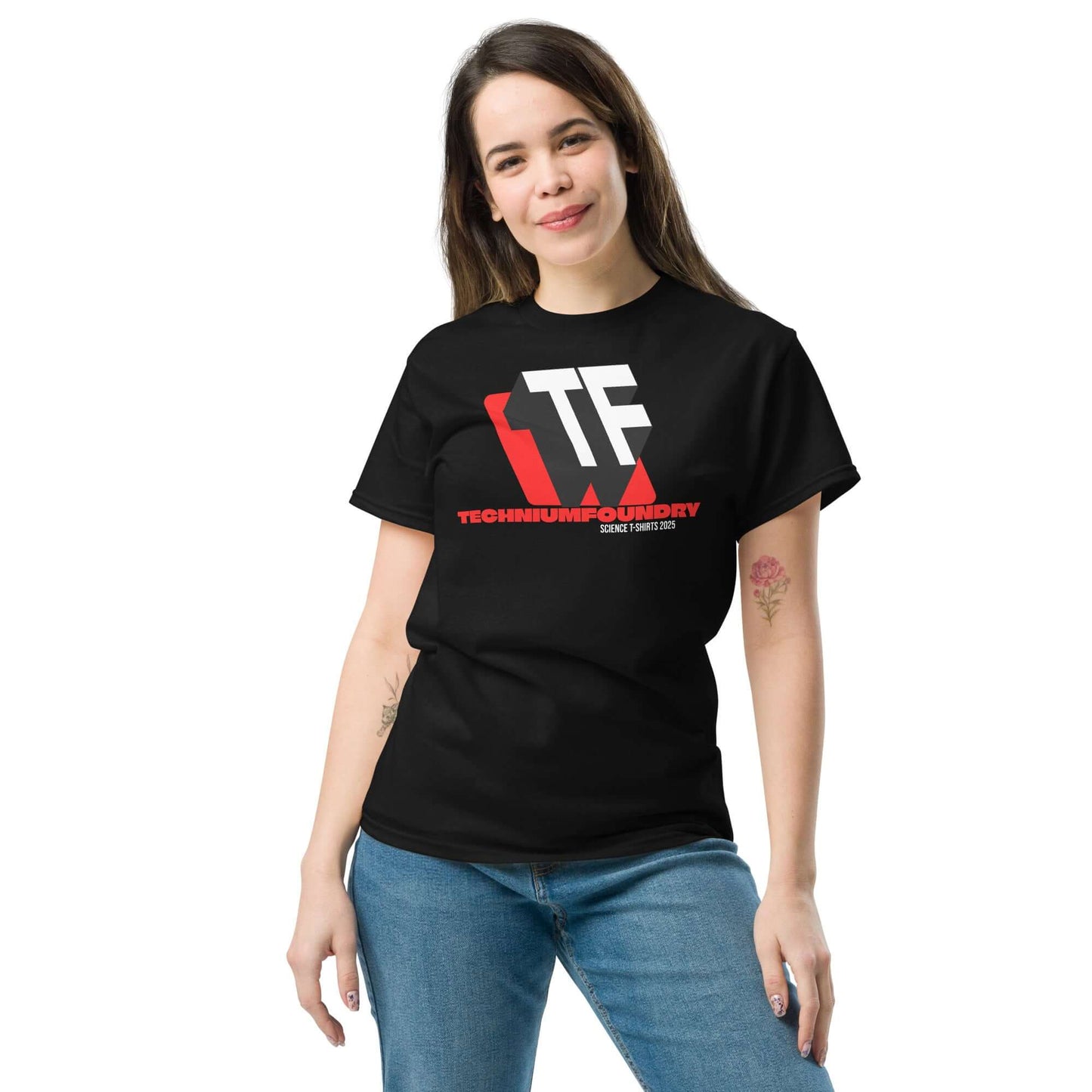 Person wearing a black Technium Foundry T-shirt featuring the bold TF logo design with red accents.