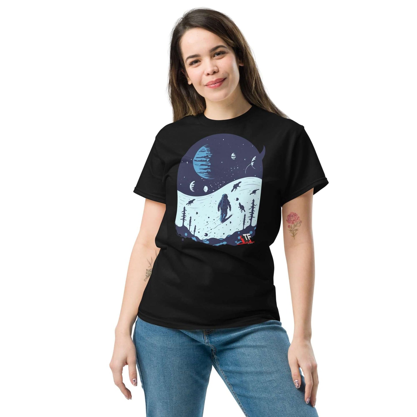 Woman wearing Space Dinosaur Slopes T-Shirt by Technium Foundry, featuring skiing T-Rex on alien planets.