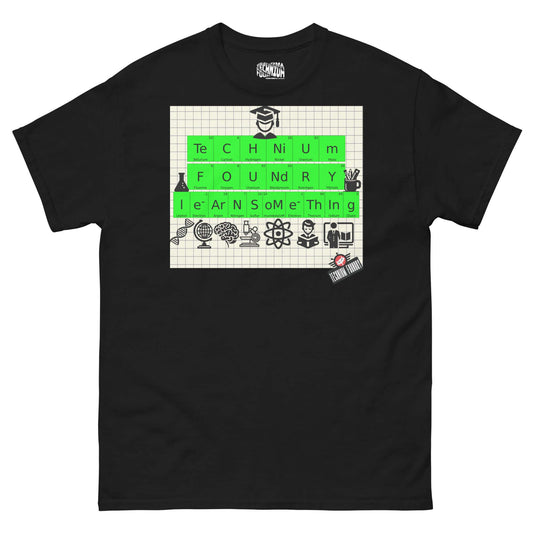 Black T-shirt featuring periodic elements spelling "TECHNIUM FOUNDRY LEARN SOMETHING" with science icons on graph paper background.