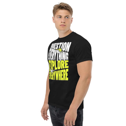 Man wearing "Question Everything Explore Everywhere" black t-shirt with bold white and yellow text, ideal for adventure enthusiasts.