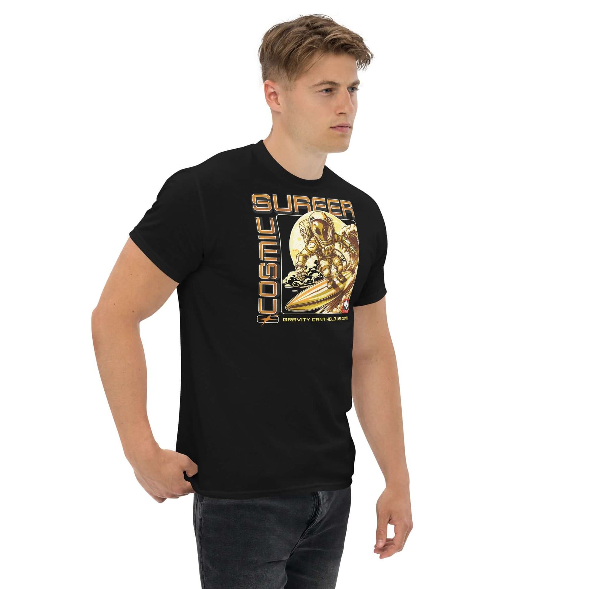 Man wearing Cosmic Surfer T-Shirt by Technium Foundry, featuring astronaut surfing design in retro-tech gold tones.