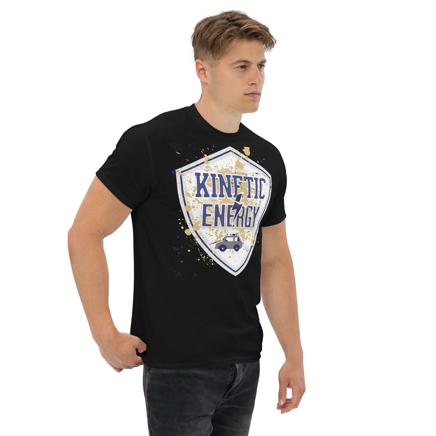 Man wearing a Kinetic Energy T-shirt with vintage shield design and small car graphic. Celebrate physics with 1/2mv² energy theme.