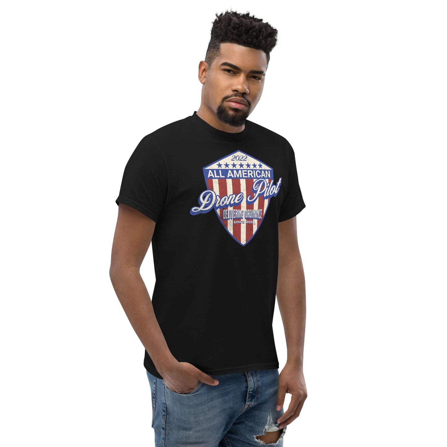 Man wearing All American Drone Pilot Champion T-Shirt with patriotic shield design, showcasing aerial performance style.