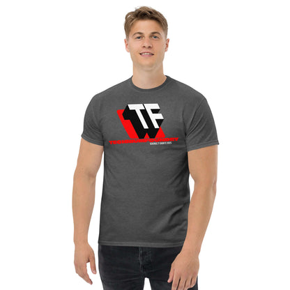 Man wearing a dark gray T-shirt with bold TF monogram logo, red accents, and Technium Foundry text, showcasing a modern design.