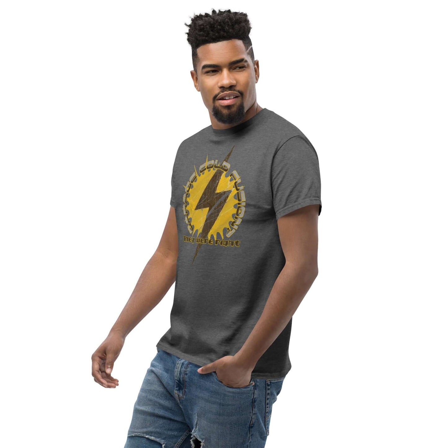 Man wearing a Garage Cold Fusion T-Shirt with lightning bolt and gear design, humorous science experiment theme.