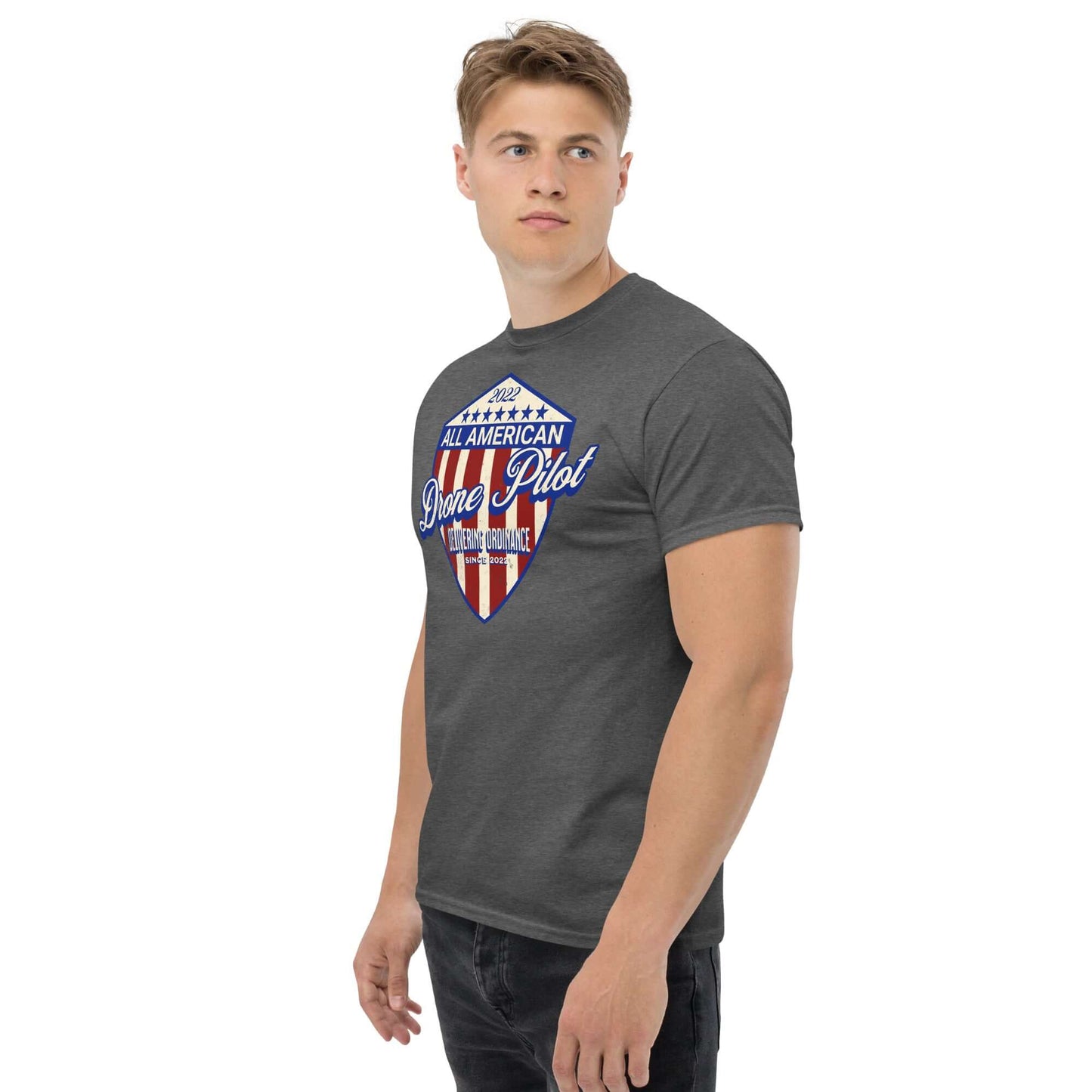 Man wearing All American Drone Pilot Champion T-Shirt with patriotic shield design, celebrating aerial superiority and pilot achievements.