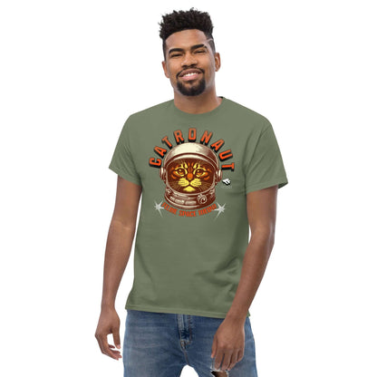 Man wearing green Catronauts t-shirt with feline astronaut design and space-themed graphics by Technium Foundry.