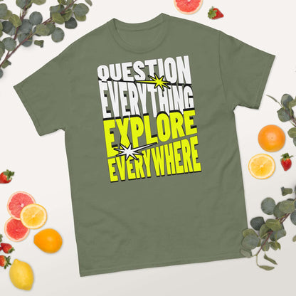 Olive green T-shirt with "Question Everything Explore Everywhere" in bold white and yellow text, surrounded by fruit and leaves.