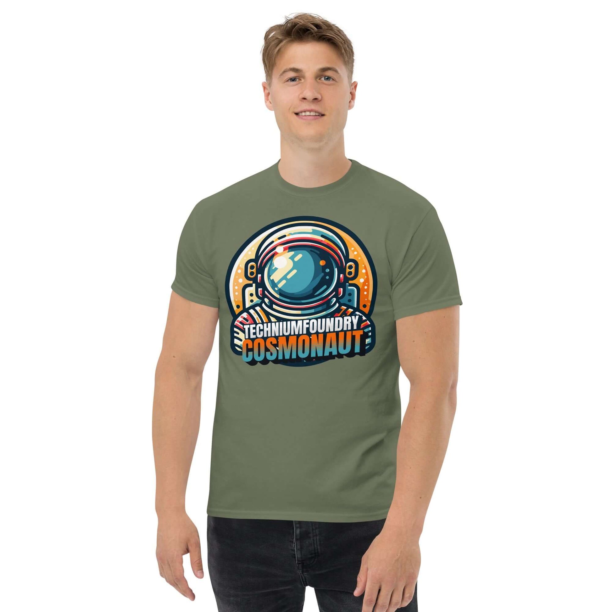 Stylish man wearing Technium Foundry Cosmonaut T-Shirt with vibrant cosmonaut helmet design on army green fabric. Retro space style.