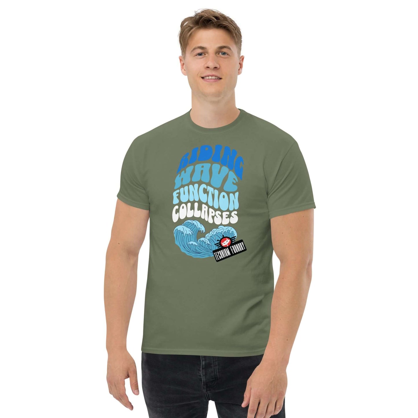 Man wearing a green Riding Wave Function Collapses T-Shirt by Technium Foundry featuring a surfing Schrödinger's Cat design.