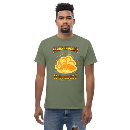 Man wearing "Stars Explode So You Can Exist" T-shirt by Technium Foundry, olive green with vibrant supernova design.