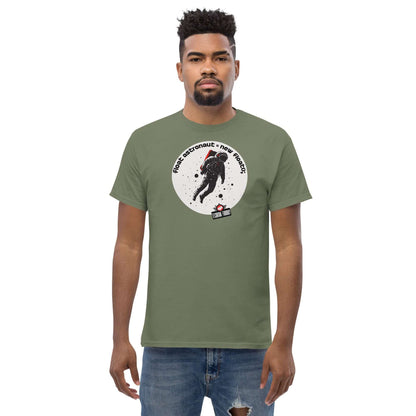 Man wearing a green t-shirt featuring an astronaut design by Technium Foundry, showcasing a space explorer floating in space.