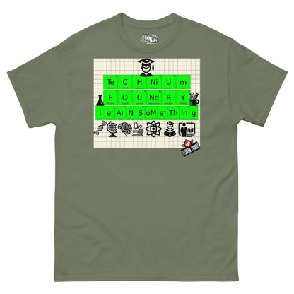 Technium Foundry T-shirt with periodic table design, educational icons, and "Learn Something" message on graph paper background.