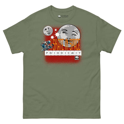 "Olive green t-shirt with 'Skate in Space Periodically' design, featuring moon and astronaut skateboarding with periodic table elements."