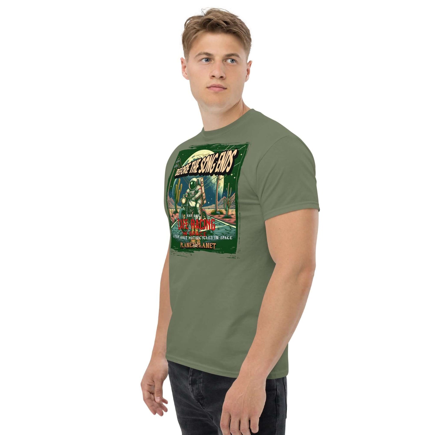 Man wearing vintage cafe racer space t-shirt with astronaut and desert design in distressed green border.