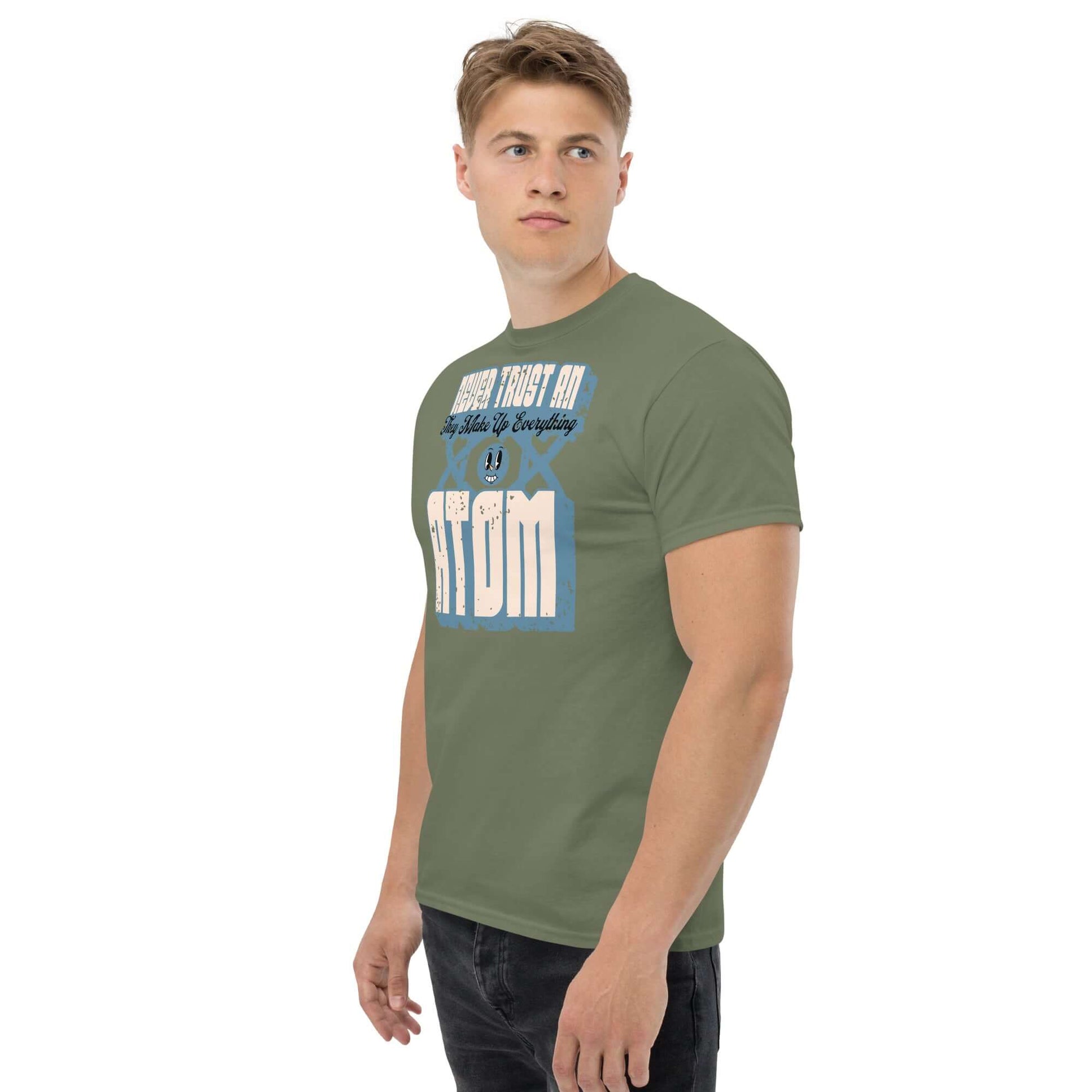 Man wearing green 'Never Trust an Atom' T-shirt featuring science pun with vintage typography.