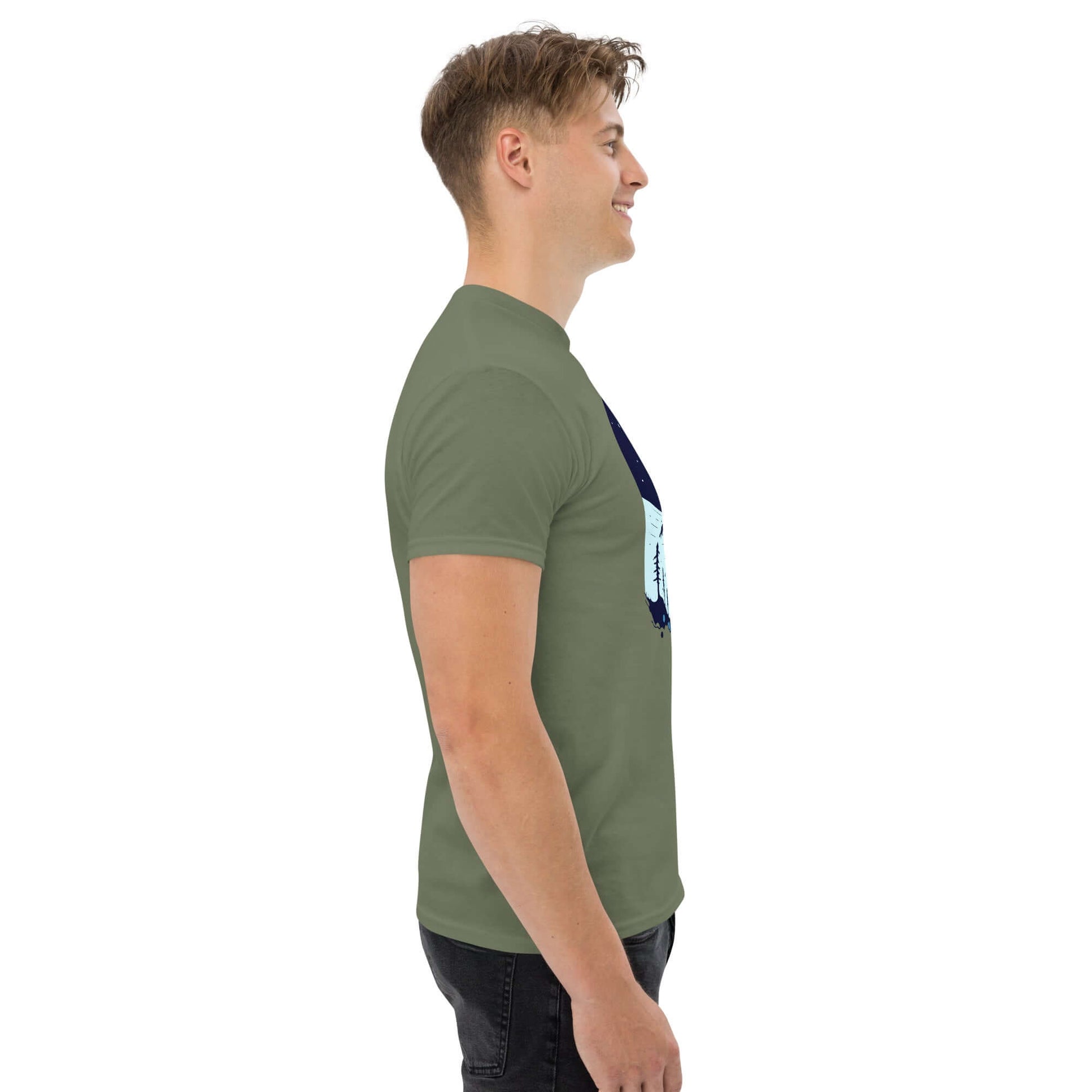 Side view of man in green Space Dinosaur Slopes T-shirt by Technium Foundry, featuring cosmic T-Rex skiing design.