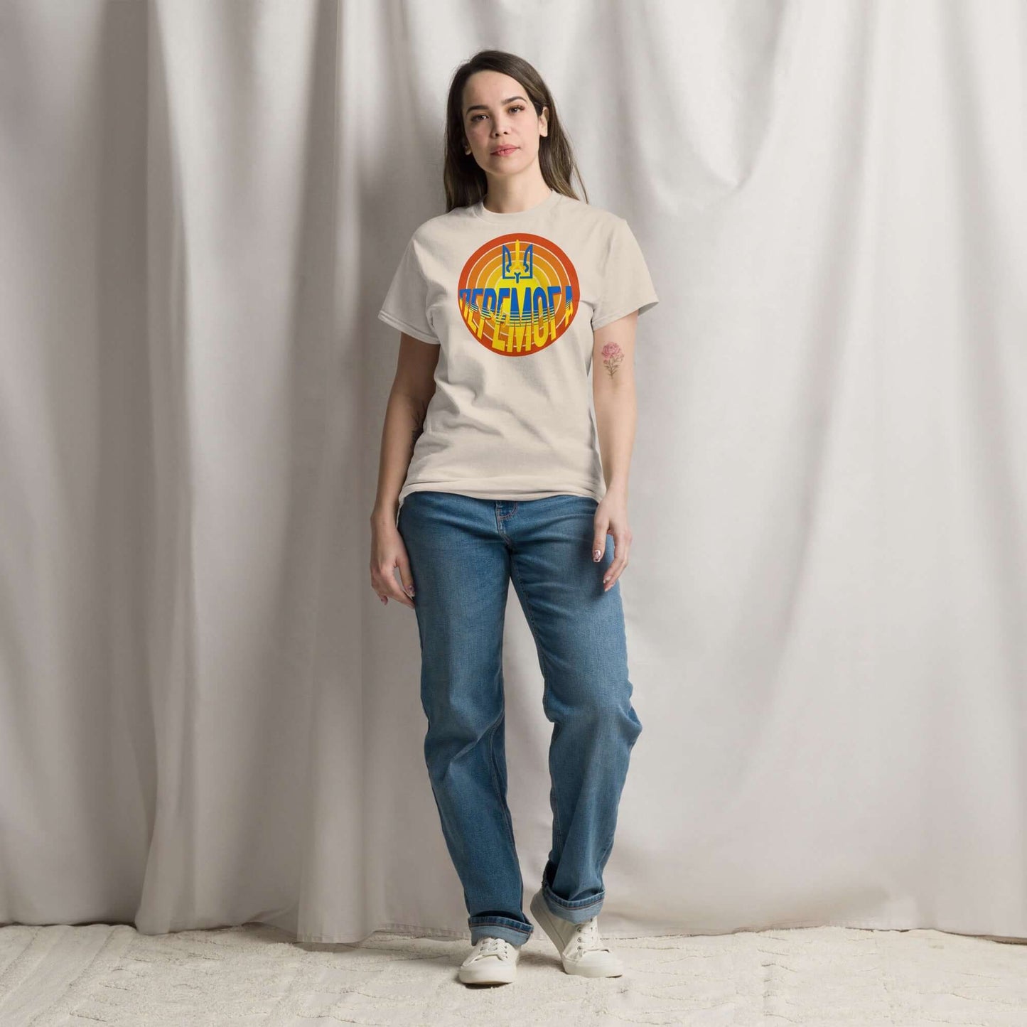 Model wearing До Перемоги Ukrainian Victory T-Shirt with iconic trident symbol and sunburst, symbolizing national pride and resilience.