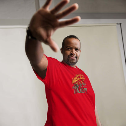 Man wearing "Ambition Without Anxiety" t-shirt in red, demonstrating confidence in mental health inspired humor apparel.