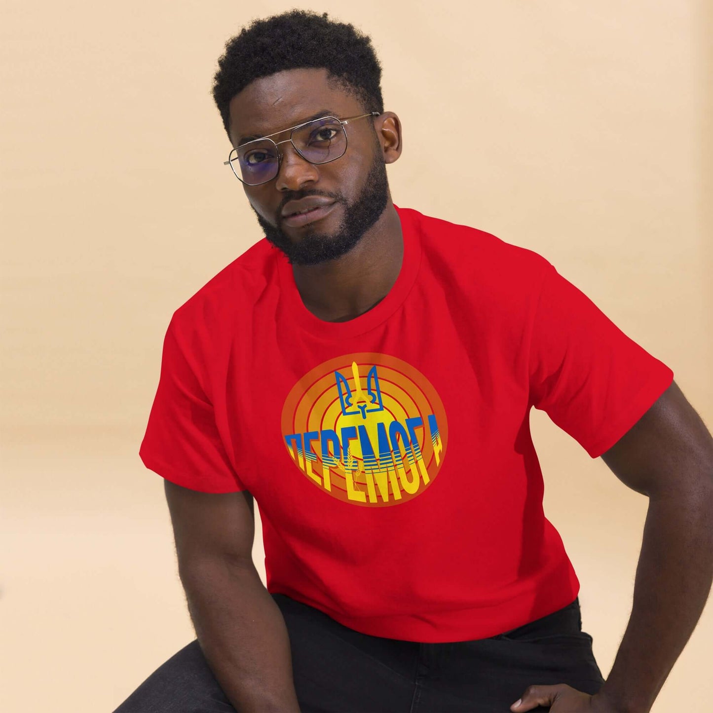 Man wearing a red Ukrainian Victory T-Shirt with 'До Перемоги' text and trident design, symbolizing national resilience.