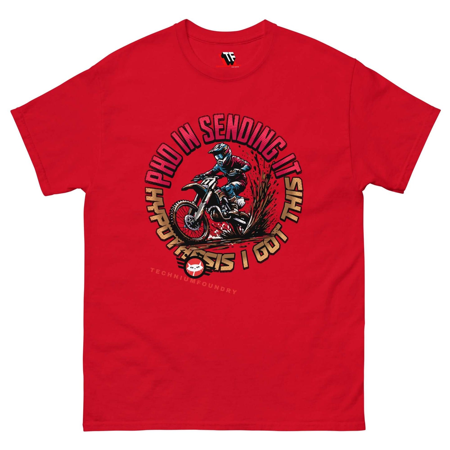 Red T-shirt with a dirt bike rider graphic and "PhD in Sending It" text by Technium Foundry, blending science and thrill aesthetics.