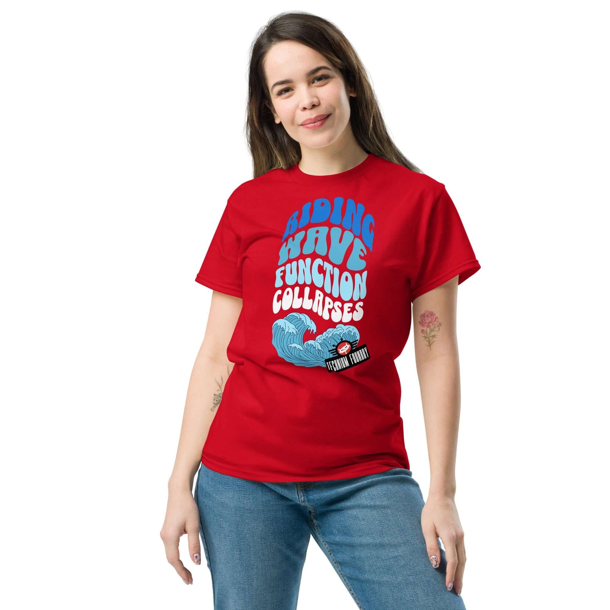 Woman wearing Riding Wave Function Collapses T-Shirt by Technium Foundry, red shirt with science geek theme and quantum apparel design.