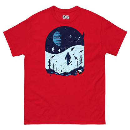 Red t-shirt featuring a space scene with an astronaut skiing alongside dinosaurs on snowy slopes under alien planets.