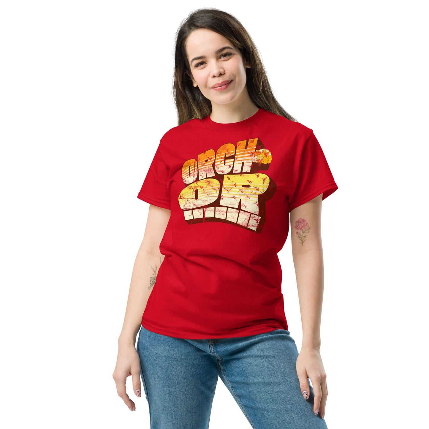 Woman wearing a red ORCH-OR t-shirt with quantum consciousness design, featuring bold dimensional typography and sunset gradient.