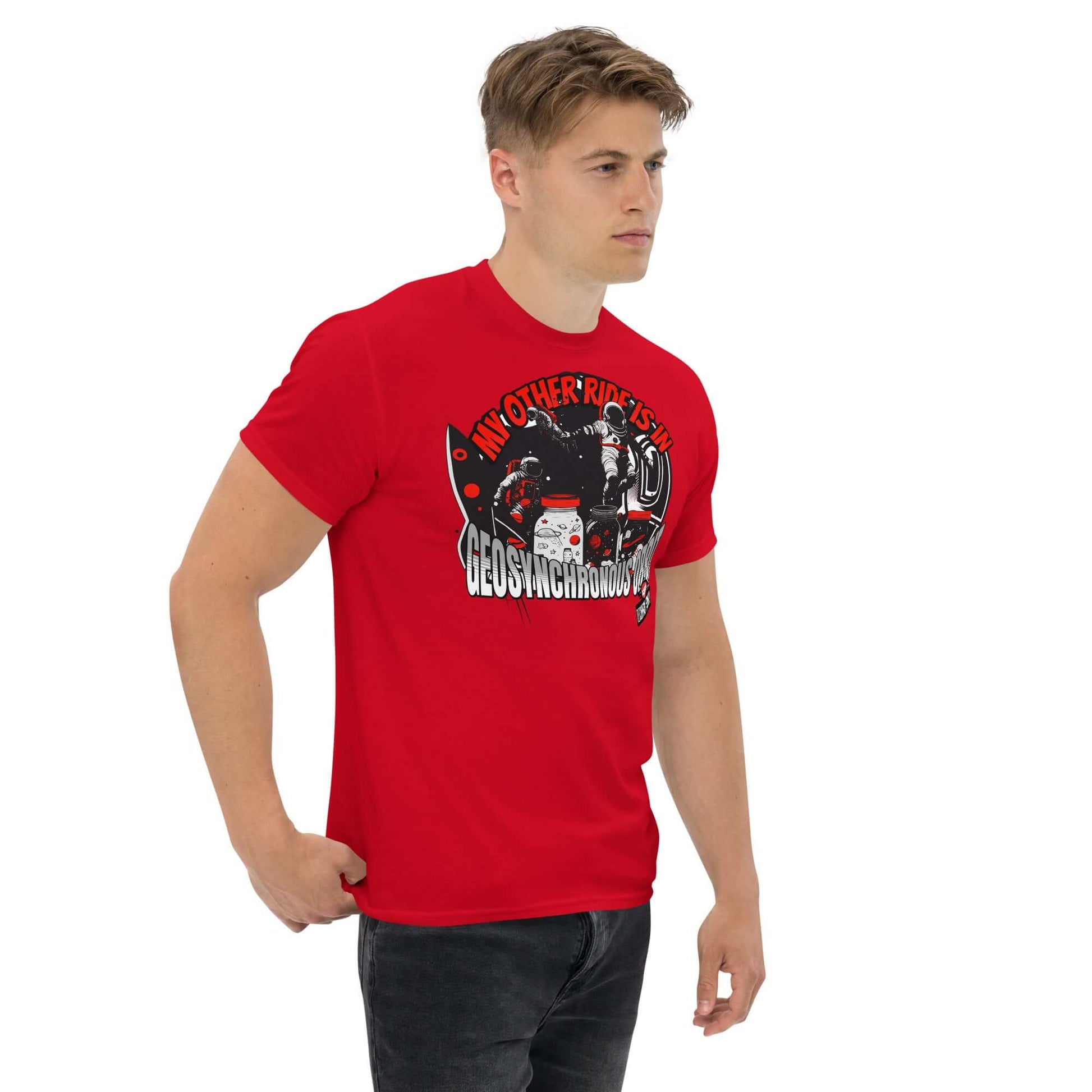 Man wearing a red "My Other Ride is in Geosynchronous Orbit" t-shirt featuring astronaut graphics by Technium Foundry.