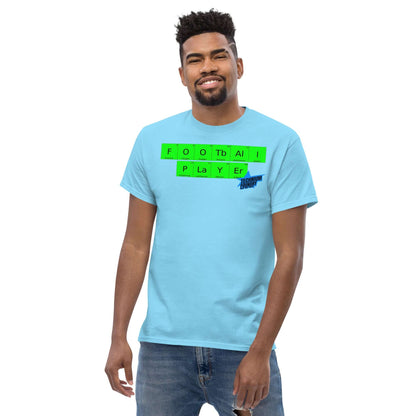 Football Player T-Shirt by Technium Foundry in blue with periodic table design, worn by a smiling person.