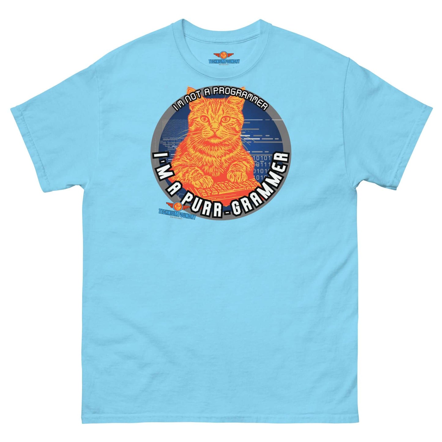 Light blue T-shirt featuring a coding cat design with the text "I'm a Purr-grammer," part of the Science & Tech Apparel Collection by Technium Foundry.