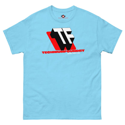 Light blue T-shirt featuring bold TF monogram logo with red accents, representing Technium Foundry's 2025 design.