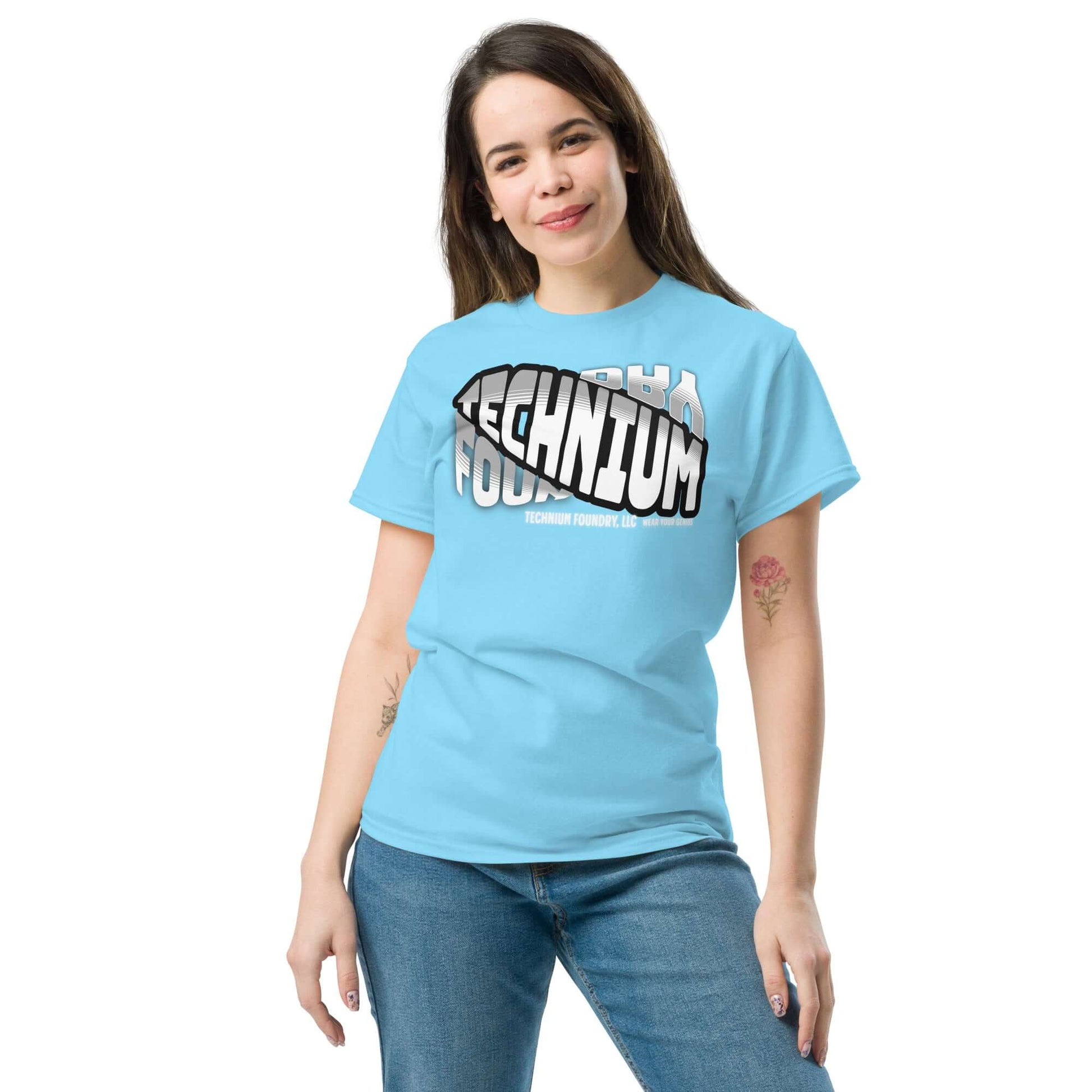 Woman wearing blue Technium Foundry Core Logo T-Shirt showcasing trendy design for science geeks, part of the quantum apparel collection.