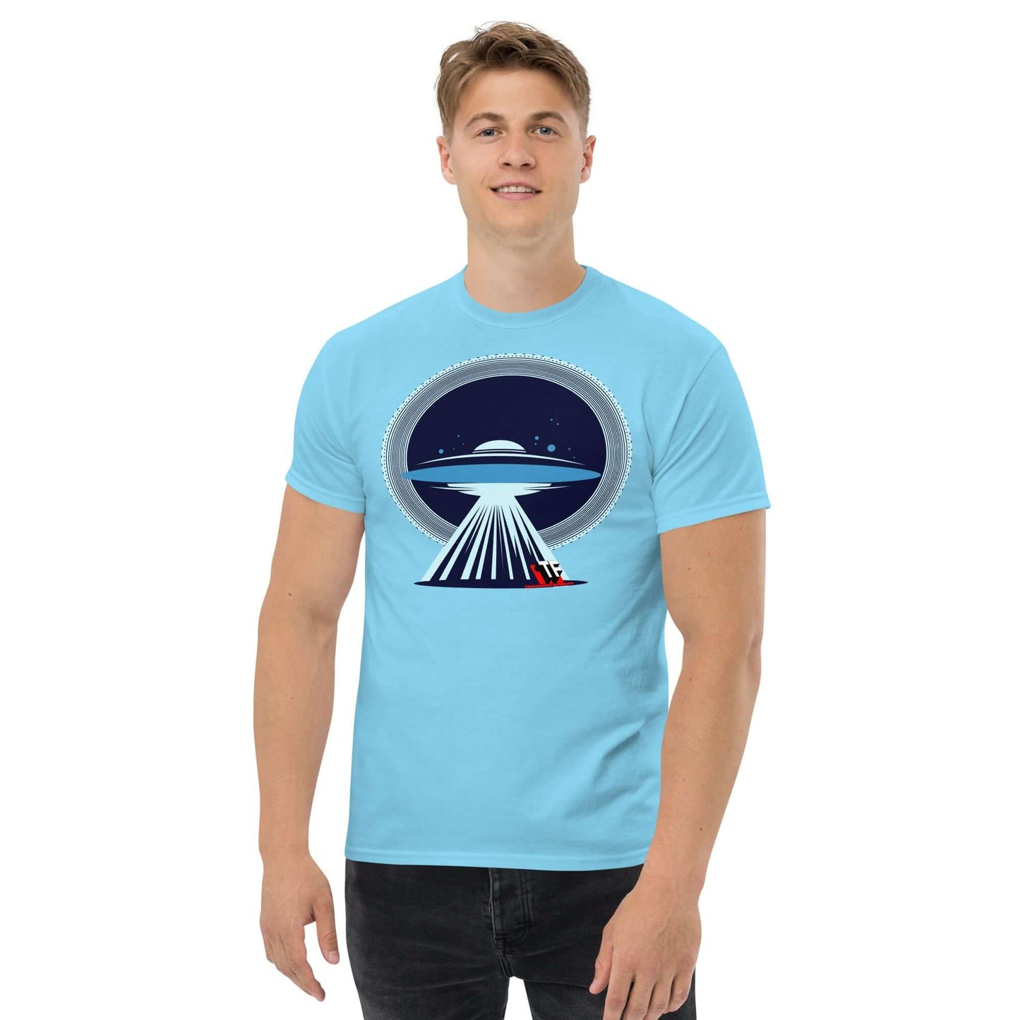 Man wearing UFO Christmas T-Shirt by Technium Foundry, featuring a UFO beaming up a red sleigh, with a festive holiday design.