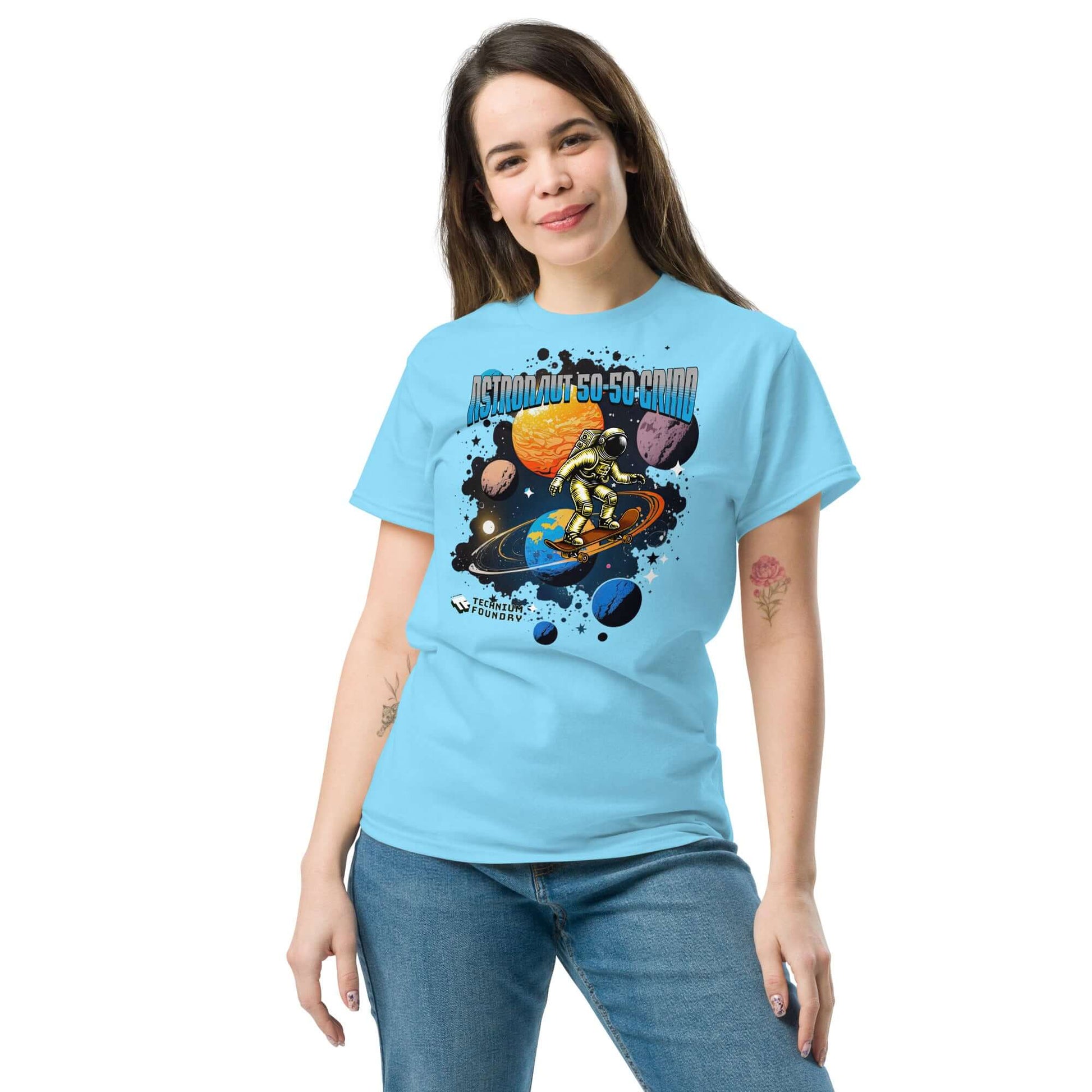 Woman wearing blue Astronaut 50-50 Grind T-shirt by Technium Foundry featuring space skater design.