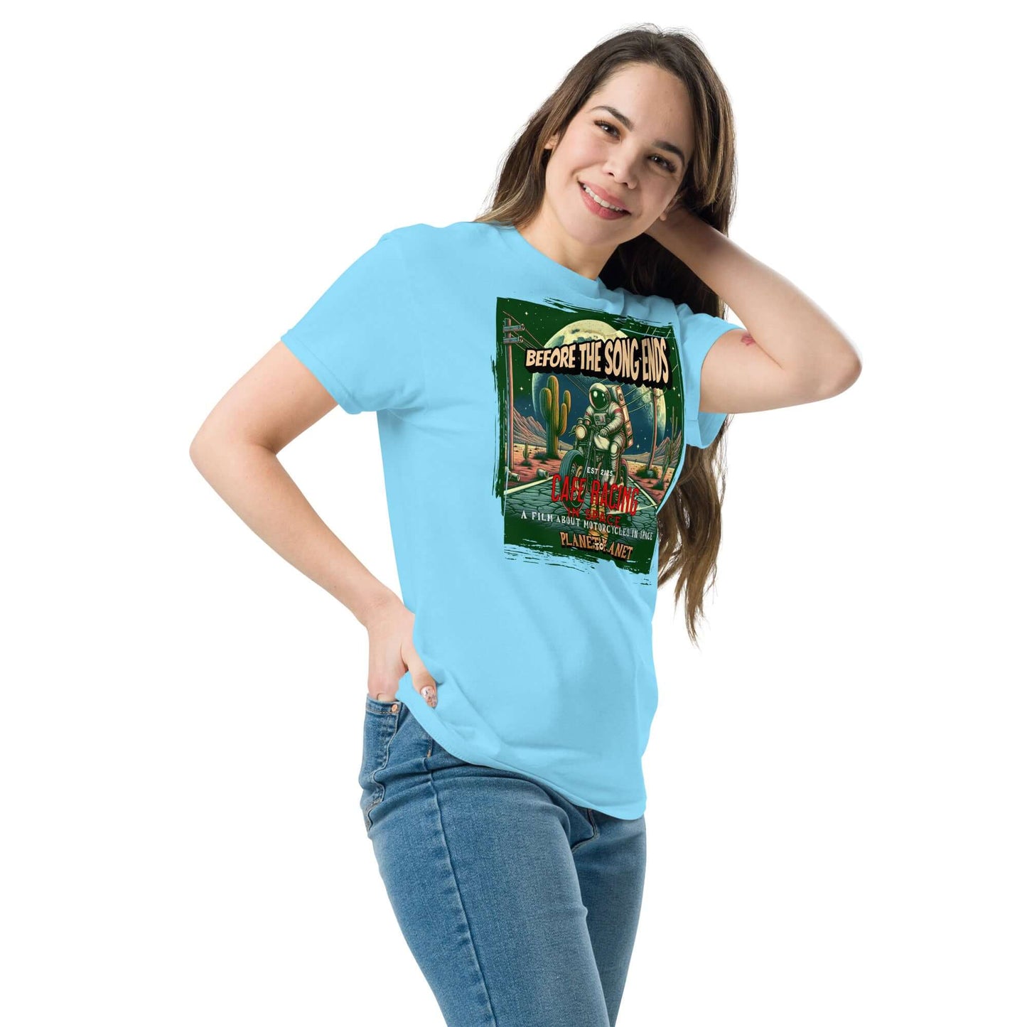 Woman wearing Cafe Racer Space T-Shirt featuring vintage astronaut and motorcycle design with desert scene and cacti.