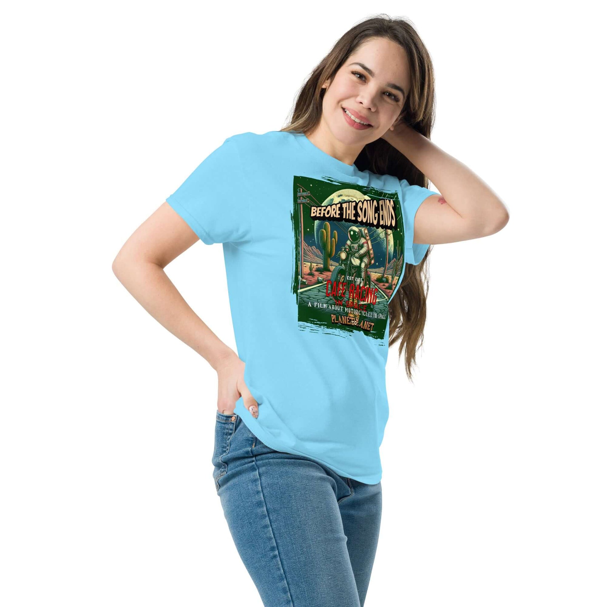 Woman wearing Cafe Racer Space T-Shirt featuring vintage astronaut and motorcycle design with desert scene and cacti.