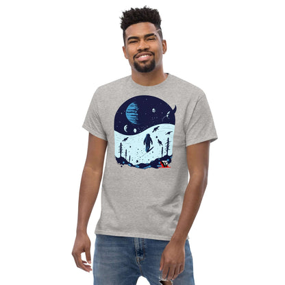 Man wearing Space Dinosaur Slopes T-Shirt by Technium Foundry, featuring astronaut and T-Rex skiing on alien planet.