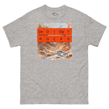 "Grey T-shirt featuring 'Geology Rocks' design with periodic elements and landscape from Technium Foundry."