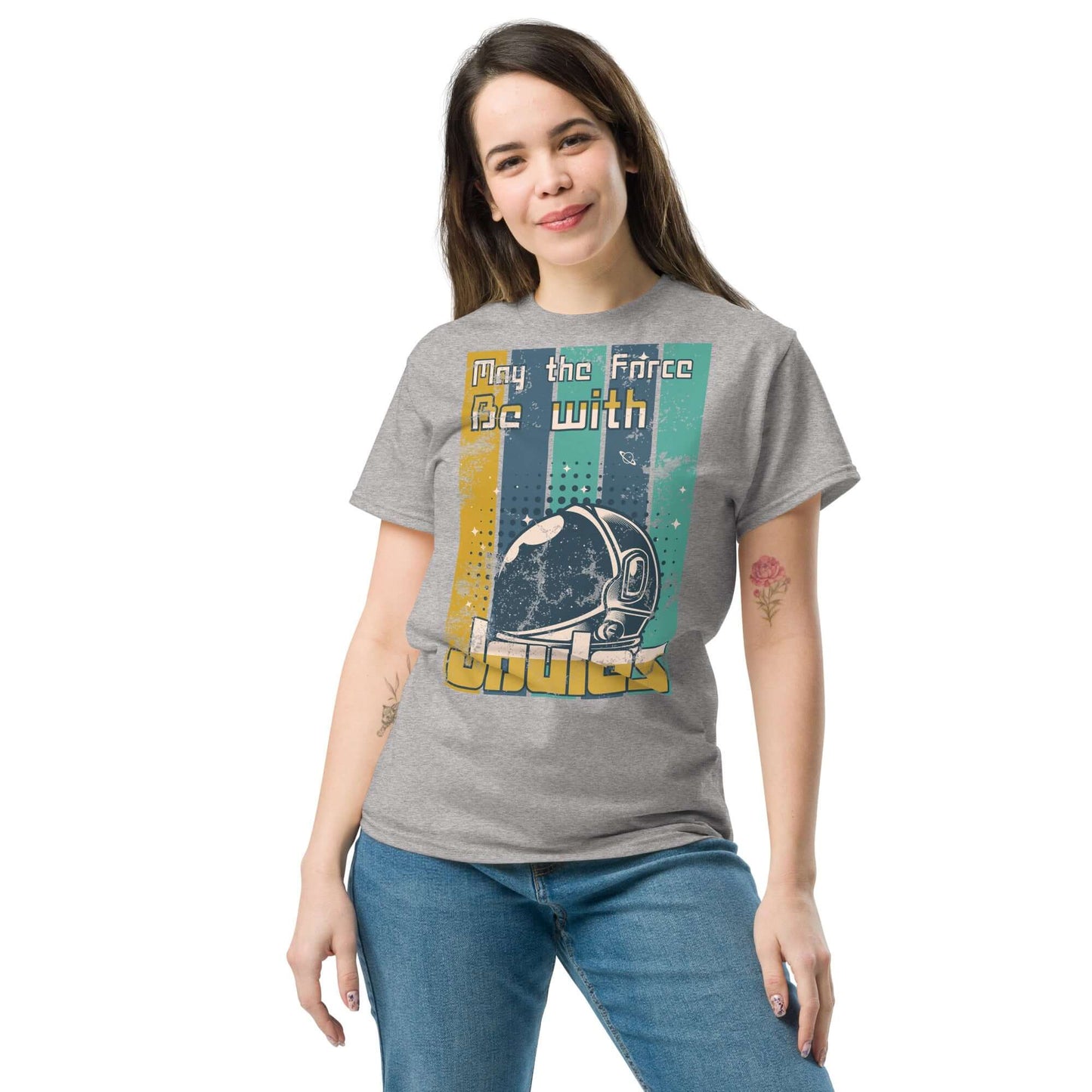 Woman wearing 'Physics Force Joules T-Shirt' with astronaut helmet design and text 'May the Force Be with Joules', blending physics and sci-fi.