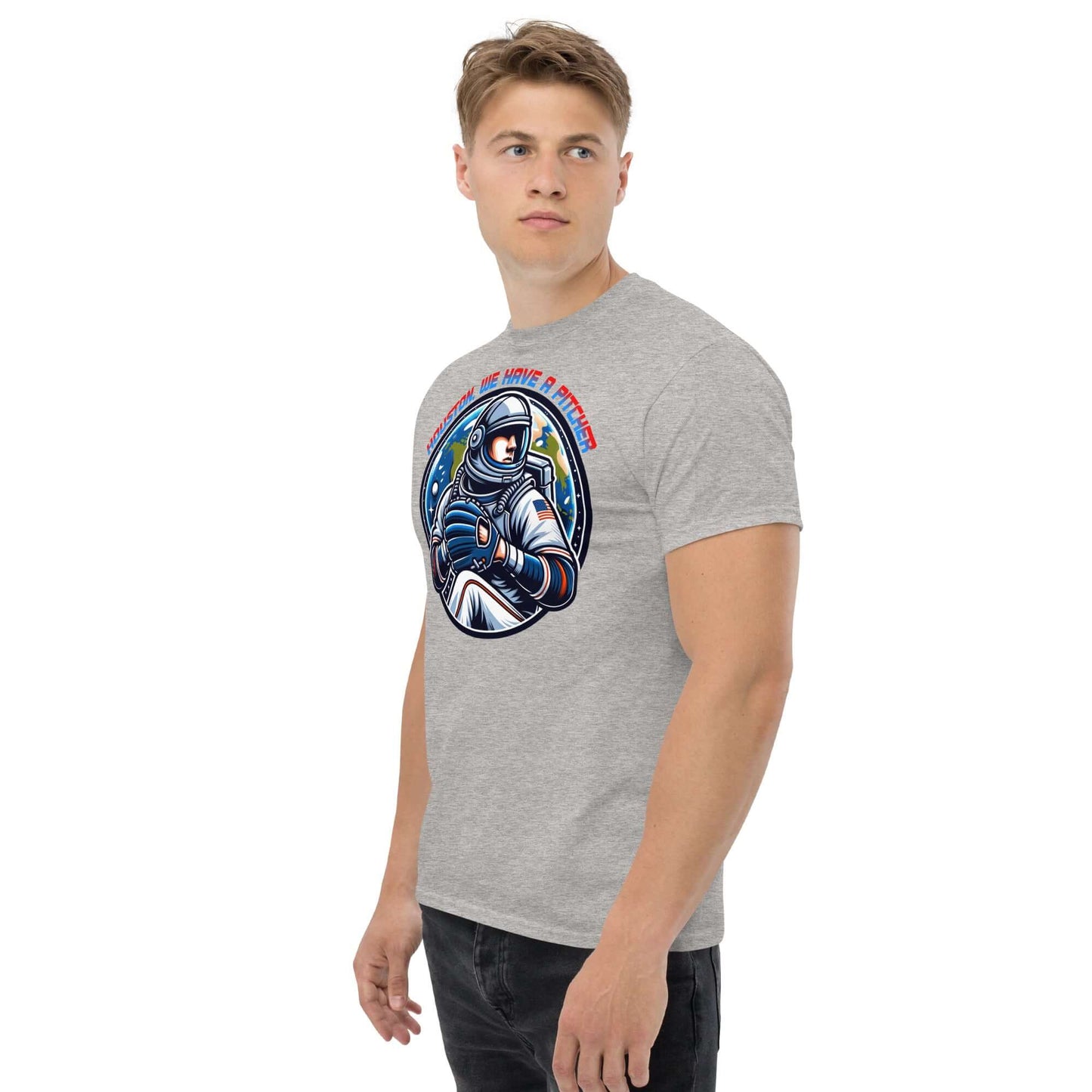 Man wearing "Houston, We Have A Pitcher" T-shirt by Technium Foundry, featuring space athlete graphic on gray fabric.