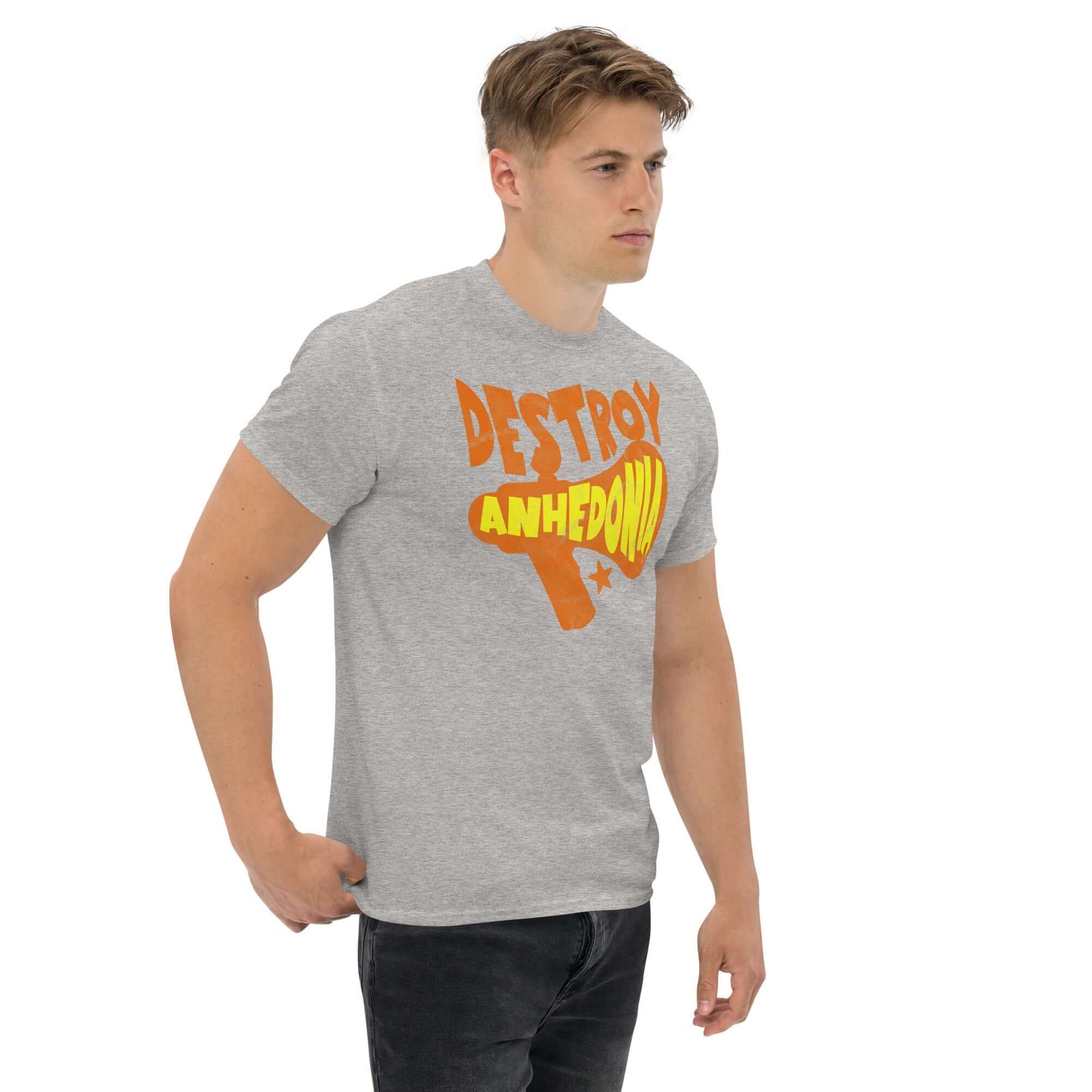 Person wearing gray 'Destroy Anhedonia' t-shirt for mental health activism, featuring bold orange and yellow graphics.