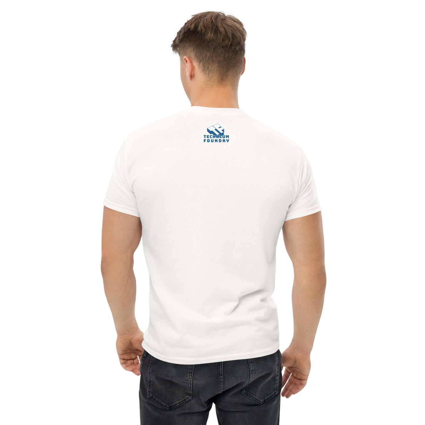 Back view of a man wearing a white T-shirt with a blue logo near the neck area, standing with hands relaxed by sides.