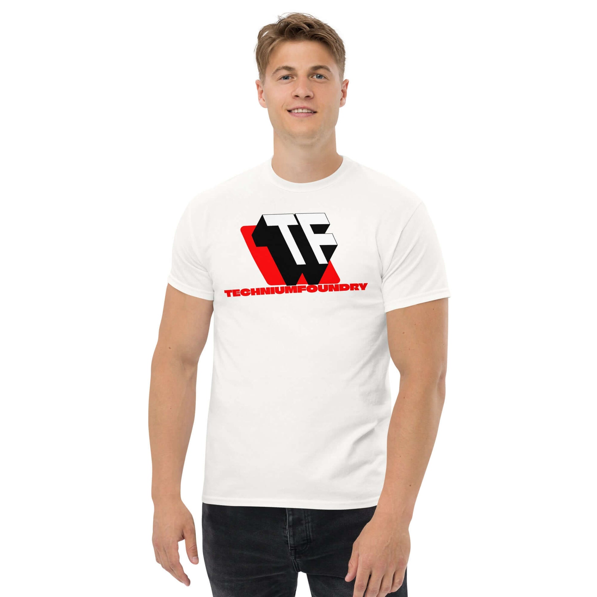 Man wearing white t-shirt featuring bold TF monogram logo with red accents for Technium Foundry, 2025 design.