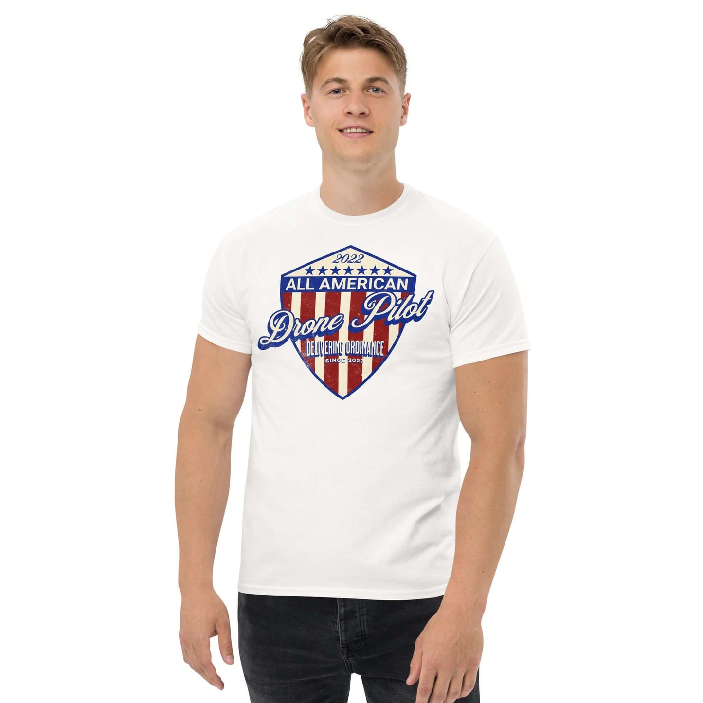 Model wearing '2022 All American Drone Pilot' Champion T-Shirt with patriotic shield design, promoting aerial performance and patriotism.