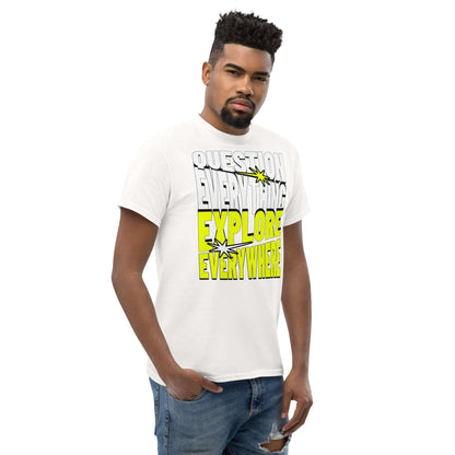 Man wearing white "Question Everything Explore Everywhere" adventure t-shirt with bold text design in white and yellow.