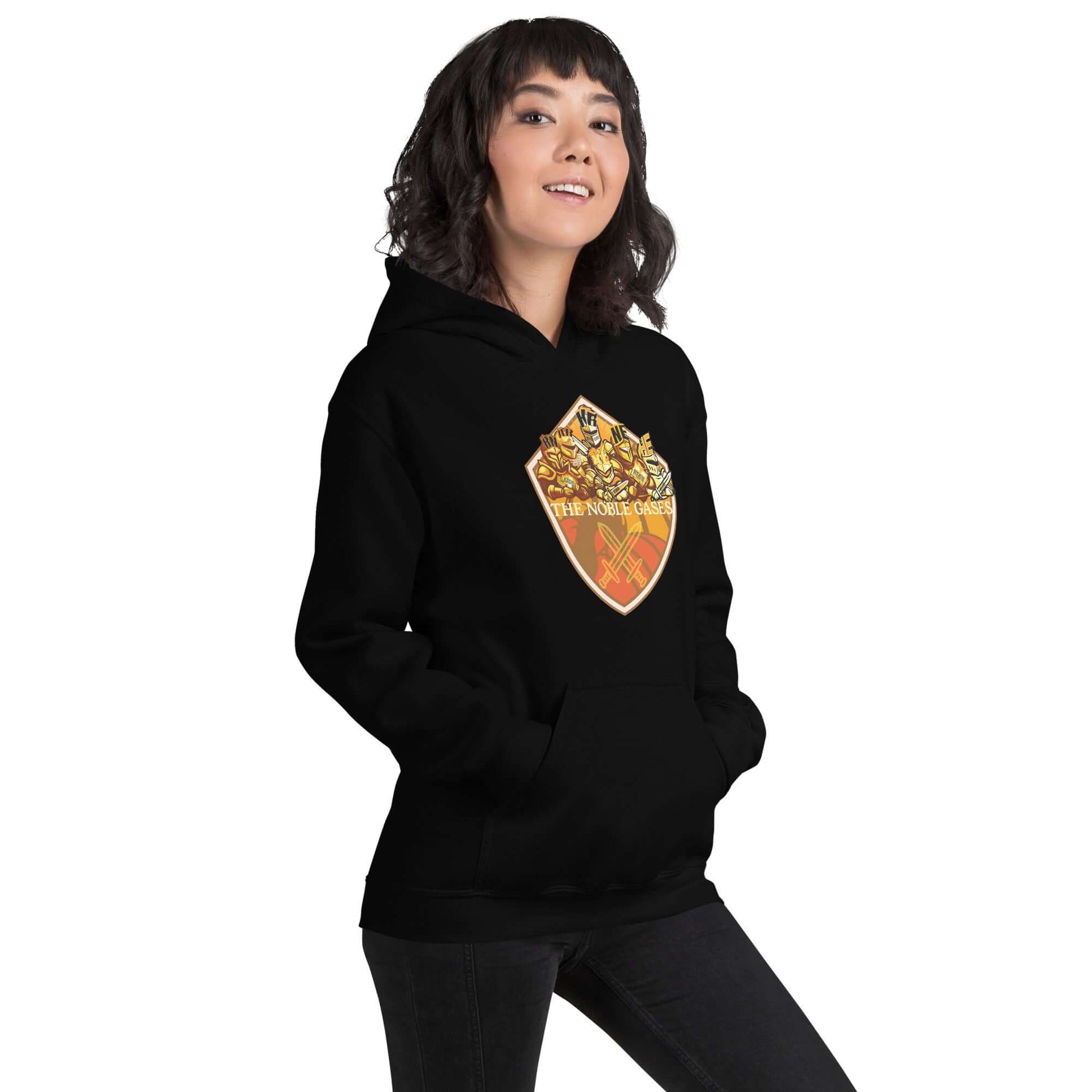 Woman wearing The Noble Gases Hoodie with periodic table shield design on black fabric.