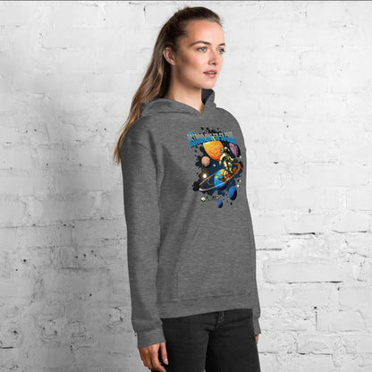 Woman wearing Astronaut 50-50 Grind Hoodie by Technium Foundry with cosmic skater graphic, standing against a white brick wall.