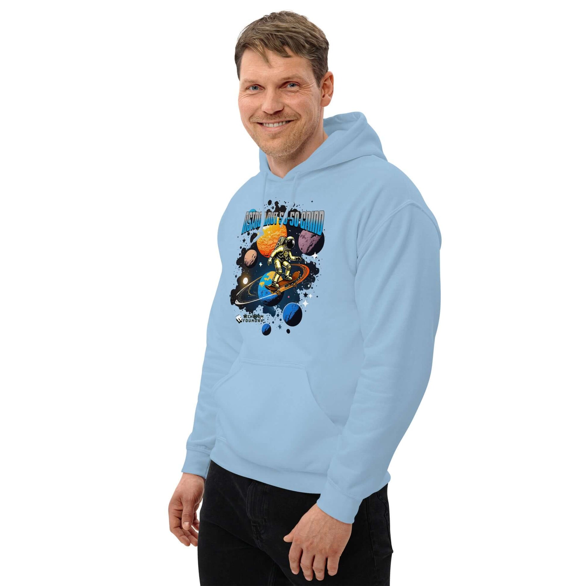 Man wearing Astronaut 50-50 Grind Hoodie by Technium Foundry with cosmic skate design on light blue background.